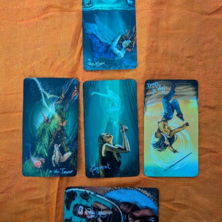 5 tarot cards in 3 rows, one on top, three in the middle and one sideways on the bottom